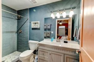a bathroom with a toilet and a sink and a mirror at Happy Palette Home Close to downtown Fenced yard in Sanford +59 photos