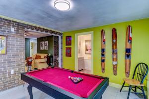 a room with a pool table and surfboards on the wall at Happy Palette Home Close to downtown Fenced yard in Sanford