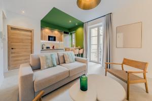 a living room with a couch and a table at Green House in Seville