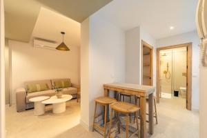 a living room with a couch and a table at Green House in Seville +123 photos