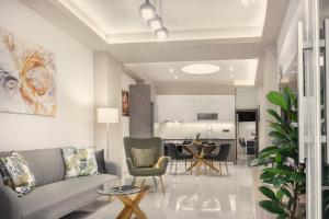 a living room with a couch and a table at Menda Suite in Heraklio