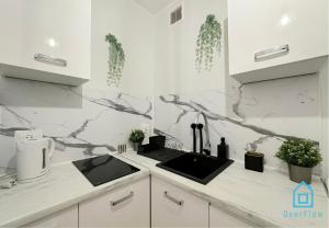 a kitchen with a sink and a counter top at Piggy Room - 3 km to Baltic Sea in Gdańsk +13 photos