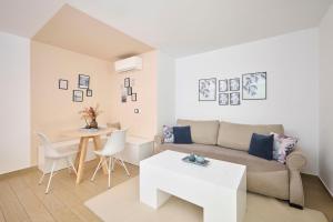 a living room with a couch and a table at Apartments Martello Garden in Poreč