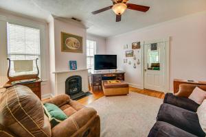 a living room with a couch and a fireplace at Historic Manor with Screened Porch in Elizabeth City in Elizabeth City