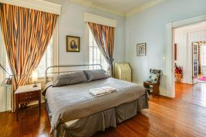 a bedroom with a bed and a wooden floor at Historic Manor with Screened Porch in Elizabeth City in Elizabeth City