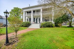 a white house with a street light in front of it at Historic Manor with Screened Porch in Elizabeth City in Elizabeth City
