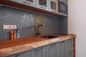 a kitchen with a sink and a counter at Grypes Deluxe Complex in Aegina Town +51 photos