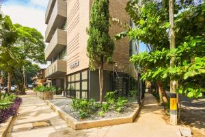 a building with trees in front of it at Firenze Lofts in Medellín +31 photos