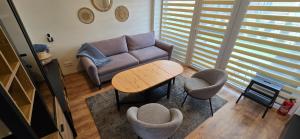 a living room with a couch and a table and chairs at Kuršių Vėjai in Palanga
