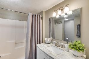 a bathroom with a sink and a mirror at Truman Lake Retreat Large Deck and On-Site Fishing! in Clinton +30 photos