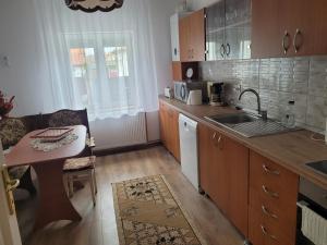 a kitchen with a small table and a sink at La matusa in Sibiu