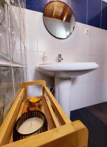 a bathroom with a sink and a mirror at Casa do Beco in Angra do Heroísmo