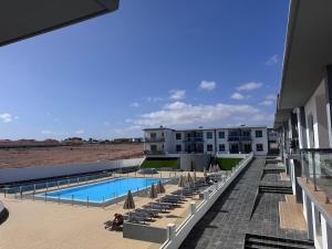 a view of the pool at a resort with umbrellas at Rosalia28 in Antigua +9 photos