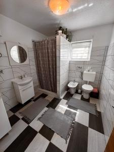 a bathroom with a toilet and a sink at Kuća za odmor Aiman in Mahala +41 photos