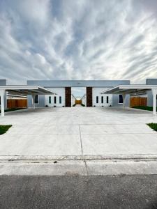 a large white building with two large wings at Gold'n Retreat in Mission