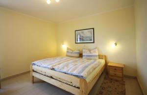 Ein Bett oder Betten in einem Zimmer der Unterkunft Achtern Diek - Ferienwohnungen