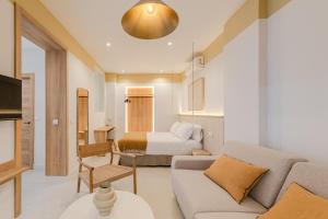 a living room with a couch and a bed at Green House in Seville