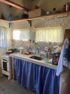 a kitchen with a sink and a counter top at Casa Aya in Ibicoara +18 photos