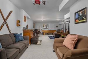 a living room with two couches and a table at Lizzie Court in Portland