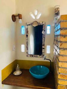 a bathroom with a blue sink and a mirror at Casa Aya in Ibicoara