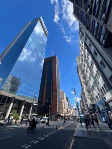 a city street with a tall building and buildings at Alto Buenos Aires in Buenos Aires
