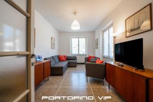 a living room with a couch and a flat screen tv at Cocca's House by PortofinoVip in Portofino
