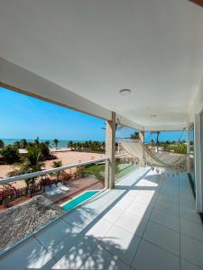 a balcony with a view of the beach at Mansão do Kite - Praia do Coqueiro in Luis Correia