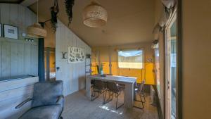 a room with a table and chairs and a couch at Luxe Safaritent in Grou in Grou +23 photos
