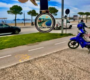 a person riding a blue scooter on a street at Vlora Vibe in Vlorë +3 photos