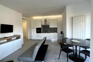 a kitchen and dining room with a table and chairs at Lake view apartment in Dormelletto