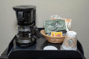 a coffee maker and a basket of food on a counter at Red Roof Inn Charlotte - University in Charlotte