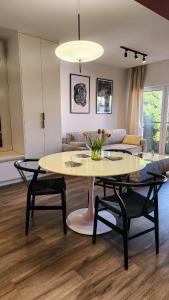 a living room with a table and chairs at Apartament Dzierżonia 12 in Katowice