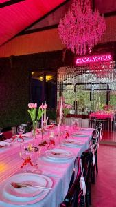 a long table with plates and wine glasses on it at Eucalyptus Cottages in Chakvi