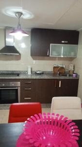 a kitchen with a table with a pink plate on it at Tanger City 5 in Tangier
