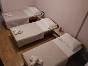 two beds in a small room with crosses on them at Pansion San Pietro in Međugorje