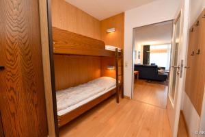 a bedroom with a bunk bed in a room at Haus "Panorama" Appartement PAN019 in Duhnen +25 photos