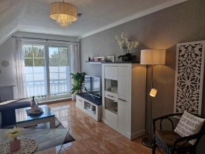a living room with a couch and a table at Lilly & Fine in Zingst