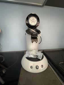 a clock sitting on top of a table at Appartement Cosy Parking, Plage & Commerces à Deux Pas in Argelès-sur-Mer