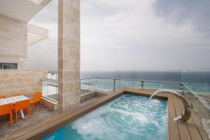 a hot tub on the balcony of a hotel at JY Luxury penthouse in Ashkelon