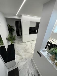 a living room with a marble floor and white cabinets at Apartament Centru Comanesti in Comăneşti
