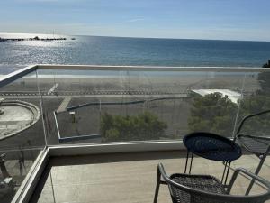 a balcony with chairs and a view of the ocean at Crystal al mar in Puerto Madryn +5 photos