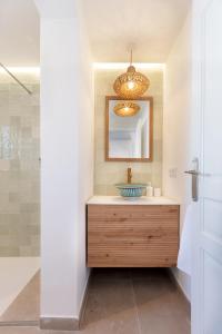 a bathroom with a sink and a mirror at K-PALM by Nuka Homes in Jávea