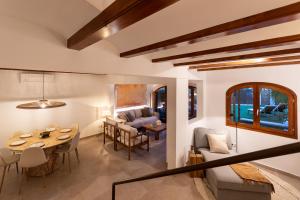 a living room with a table and a dining room at K-PALM by Nuka Homes in Jávea +52 photos