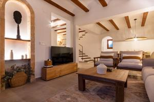 a living room with a couch and a tv at K-PALM by Nuka Homes in Jávea