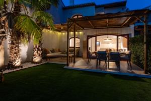an outdoor dining area with a table and a patio at K-PALM by Nuka Homes in Jávea