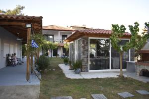 a house with a yard with a patio at Irina's Stoudio 7 in Psakoudia +11 photos