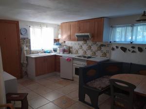 a kitchen with a sink and a stove top oven at Ferienwohnung mit Privatpool Casa Wende in Benaguacil