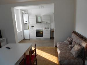 a kitchen and living room with a couch and a table at La casa nel verde in Nemeggio