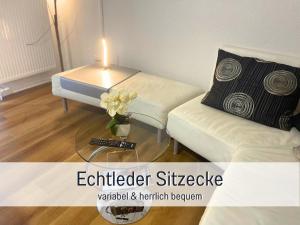 a living room with a couch and a table with a candle at OLIVE - Ruhe & Entspannung in 2-Zi-Fewo mit Garten-Whirlpool, Terrasse & Hund willkommen by FerienWohnenAmSee in Überlingen +45 photos