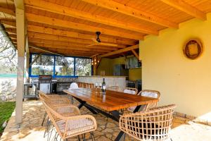 a wooden table and chairs on a patio at Bella di Campo in Rovinj
